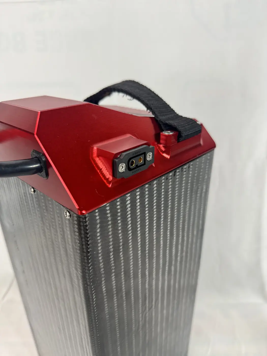Close detail of the LB 60/60's machined red cap, carry strap and QS10-P connector port